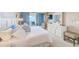 Comfortable bedroom with balcony access, ocean views, and white furniture for a relaxing retreat at 17940 Gulf Blvd # 2B, Redington Shores, FL 33708