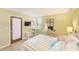 Bright bedroom with a cozy bed, work area, and neutral tones at 17940 Gulf Blvd # 2B, Redington Shores, FL 33708