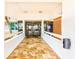 Welcoming entrance foyer with tile flooring leading to glass doors at 17940 Gulf Blvd # 2B, Redington Shores, FL 33708