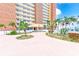 Attractive condo building with palm trees and a circular driveway at 17940 Gulf Blvd # 2B, Redington Shores, FL 33708