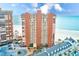 Beautiful exterior view of beachfront condo tower, showcasing balconies and ocean view at 17940 Gulf Blvd # 2B, Redington Shores, FL 33708
