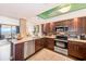 This open concept kitchen features stainless appliances, granite countertops and wood cabinets at 17940 Gulf Blvd # 2B, Redington Shores, FL 33708