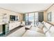 Living room with stunning ocean views, balcony access, contemporary furnishings, and accent pieces at 17940 Gulf Blvd # 2B, Redington Shores, FL 33708