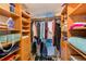 Spacious walk-in closet featuring wooden shelves, drawers, and hanging racks for optimal storage and organization at 17940 Gulf Blvd # 2B, Redington Shores, FL 33708