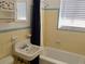 Bathroom with yellow ceramic tile walls and a white tub, sink and toilet at 1800 Pass A Grille Way # 5, St Pete Beach, FL 33706