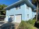 Bright two-story home with a two-car garage, well-maintained landscaping, and classic architectural details under a clear blue sky at 1800 Pass A Grille Way # 5, St Pete Beach, FL 33706