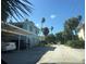 View of a home and street, showcasing a blend of residential living and outdoor charm with ample parking at 1800 Pass A Grille Way # 5, St Pete Beach, FL 33706