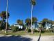 Exterior view of a blue building with palm trees and landscaping at 1800 Pass A Grille Way # 5, St Pete Beach, FL 33706