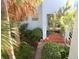 View of building entrance surrounded by lush, tropical landscaping at 1800 Pass A Grille Way # 5, St Pete Beach, FL 33706