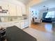 Kitchen with white cabinets and appliances, and ceramic tile and hardwood floors at 1800 Pass A Grille Way # 5, St Pete Beach, FL 33706