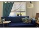 Living room with natural light, a blue couch with decorative pillows and views of outdoor landscape at 1800 Pass A Grille Way # 5, St Pete Beach, FL 33706