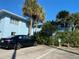 Convenient parking area with lush landscaping and palm trees enhancing the curb appeal of this inviting residence at 1800 Pass A Grille Way # 5, St Pete Beach, FL 33706
