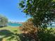 Scenic water view showcasing the tranquil waters and picturesque waterfront homes from a leafy green space at 1800 Pass A Grille Way # 5, St Pete Beach, FL 33706
