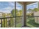 Balcony with railing providing views of the neighborhood and surrounding landscape on a sunny day at 18445 Bridle Club Dr, Tampa, FL 33647