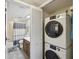 Bathroom with sink, toilet, shower-tub, mirror, and laundry closet with stacked machines, skylight at 2009 Hammock Pine Blvd # 2009, Clearwater, FL 33761