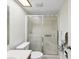 Bathroom featuring a framed sliding glass shower door, skylight, toilet, and countertop sink at 2009 Hammock Pine Blvd # 2009, Clearwater, FL 33761