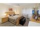 Comfortable bedroom with neutral tones, a ceiling fan, and natural light with warm-colored flooring at 2009 Hammock Pine Blvd # 2009, Clearwater, FL 33761