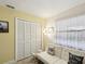 Bedroom featuring a futon, large closet with sliding doors, and an open window for natural light at 2009 Hammock Pine Blvd # 2009, Clearwater, FL 33761