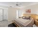 Comfortable bedroom featuring a large bed, neutral tones and flooring, and a ceiling fan with natural light at 2009 Hammock Pine Blvd # 2009, Clearwater, FL 33761