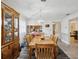 Dining area with wooden table, seating for six, and a view into the adjacent kitchen at 2009 Hammock Pine Blvd # 2009, Clearwater, FL 33761