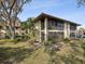 Charming exterior view of home with lush landscaping and mature trees at 2009 Hammock Pine Blvd # 2009, Clearwater, FL 33761