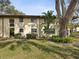 Exterior of the condo with well-maintained landscaping and mature trees at 2009 Hammock Pine Blvd # 2009, Clearwater, FL 33761