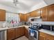 Kitchen featuring light-colored countertops, stainless steel appliances, and a window with natural light at 2009 Hammock Pine Blvd # 2009, Clearwater, FL 33761