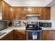 Well-lit kitchen with stainless steel appliances, oak cabinetry, and ample countertop space at 2009 Hammock Pine Blvd # 2009, Clearwater, FL 33761