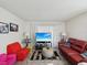 Cozy living room with red sofa, beach-themed decor, and light-colored walls at 2009 Hammock Pine Blvd # 2009, Clearwater, FL 33761