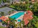 Aerial view of a community pool, hot tub, tennis courts, and lush landscaping at 2009 Hammock Pine Blvd # 2009, Clearwater, FL 33761