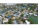 Aerial view of neighborhood showcasing waterfront properties, mature trees, and community layout at 2037 Church Creek Pt, Largo, FL 33774