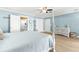 Bright bedroom with white four-poster bed, light wood floors, and coastal decor at 2037 Church Creek Pt, Largo, FL 33774
