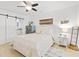 Bright bedroom with sliding barn door, wooden floors, and beachy decor at 2037 Church Creek Pt, Largo, FL 33774
