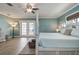 Light-filled bedroom with a canopy bed, ceiling fan, and French doors leading to the outside at 2037 Church Creek Pt, Largo, FL 33774