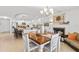 Elegant dining room with modern lighting, a cozy fireplace, and an open view to the kitchen at 2037 Church Creek Pt, Largo, FL 33774