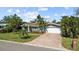 Charming one-story home with a brick driveway, lush landscaping, and a well-manicured lawn at 2037 Church Creek Pt, Largo, FL 33774