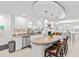 Charming kitchen with white cabinetry, an island, stainless appliances, and granite countertops at 2037 Church Creek Pt, Largo, FL 33774