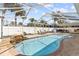 A large pool with a built in water feature in a backyard with screened lanai at 2037 Church Creek Pt, Largo, FL 33774