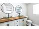 Bathroom vanity with dual vessel sinks, wooden countertop, and tile floor at 2080 Attache Ct, Clearwater, FL 33764