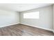 Bright bedroom featuring wood floors, white trim and baseboards, light gray paint and a window at 2080 Attache Ct, Clearwater, FL 33764
