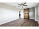Bedroom with wood floors, ceiling fan, barn door closet and neutral color paint at 2080 Attache Ct, Clearwater, FL 33764