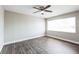 Neutral bedroom with a ceiling fan and a large window at 2080 Attache Ct, Clearwater, FL 33764