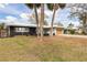 Beautiful home with a well-kept lawn, a large tree, and an attached garage at 2080 Attache Ct, Clearwater, FL 33764