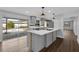 Modern kitchen with new cabinets, stainless steel appliances, and a sliding glass door to the backyard at 2080 Attache Ct, Clearwater, FL 33764