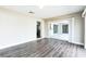 Living room featuring wood floors, sliding glass doors, with view into kitchen area at 2080 Attache Ct, Clearwater, FL 33764