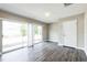 Living room showcasing wood floors, natural lighting, sliding glass doors to backyard at 2080 Attache Ct, Clearwater, FL 33764
