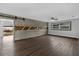 Spacious living room featuring a decorative wood wall and sliding barn door at 2080 Attache Ct, Clearwater, FL 33764