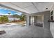 Covered outdoor patio with paver flooring and view to backyard and living room at 2080 Attache Ct, Clearwater, FL 33764