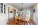 Cozy dining room features wood floors, a unique table, built-in cabinet, and natural light at 2505 W Morrison Ave, Tampa, FL 33629