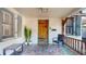 Inviting front porch boasting stone flooring, wooden door with a decorative touch, and covered from the elements at 2505 W Morrison Ave, Tampa, FL 33629